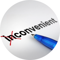 Word 'inconvenient' printed on a page with a red cross through the beginning part, symbolizing a correction or revision; a blue pen nearby emphasizes the act of editing, highlighting improvement or adjustment in meaning.