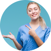 Cheerful young woman in blue scrubs pointing to her right with a welcoming smile; solid light blue background emphasizes a bright, approachable, and professional vibe, ideal for promoting healthcare or medical services.